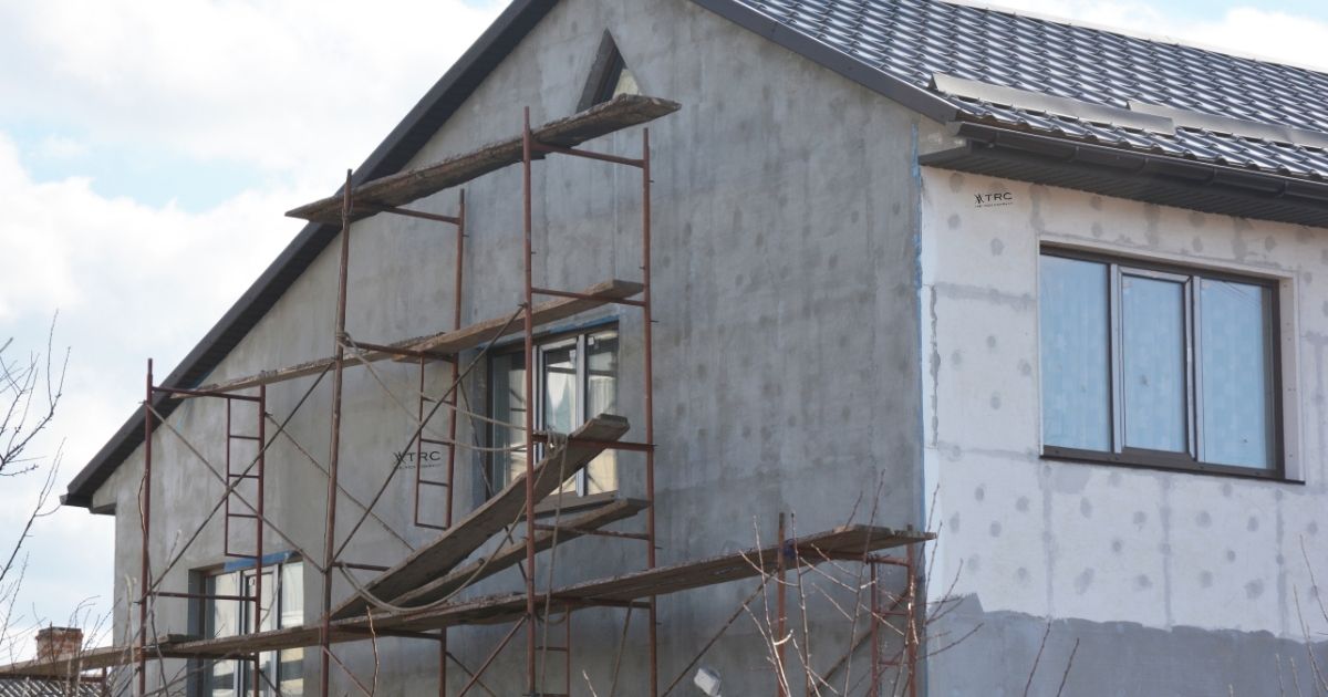 The Rich Co Inc. crew repairing cracked exterior stucco on a Colorado Springs home