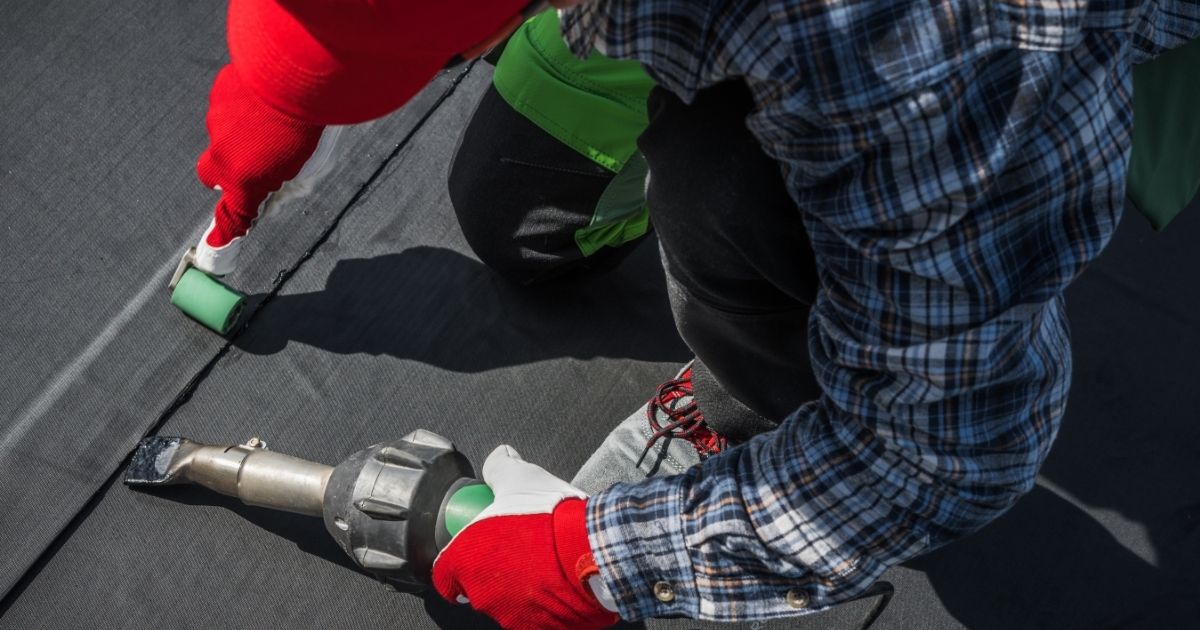 The Rich Co Inc. crew performing a rubber roof replacement on a flat roof in Colorado Springs, CO