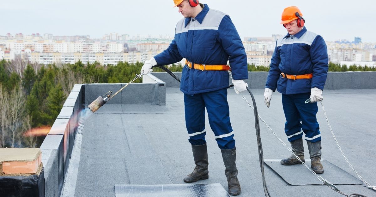 The Rich Co Inc. crew installing a flat membrane roof on a Colorado Springs building