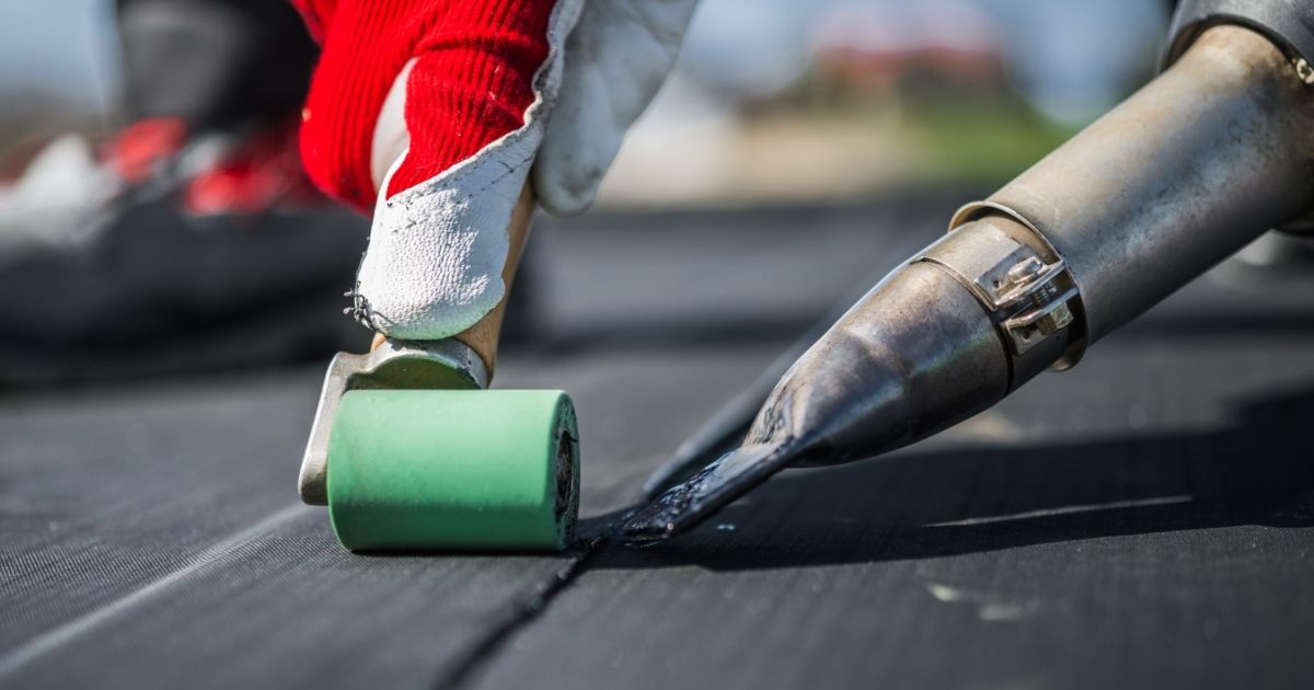 The Rich Co Inc. crew installing an EPDM rubber roof on a flat roof in Colorado Springs, Colorado